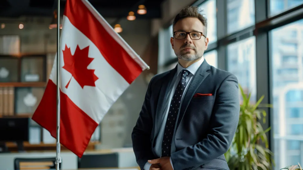 Canadian Immigration Consultant standing with Canada flag